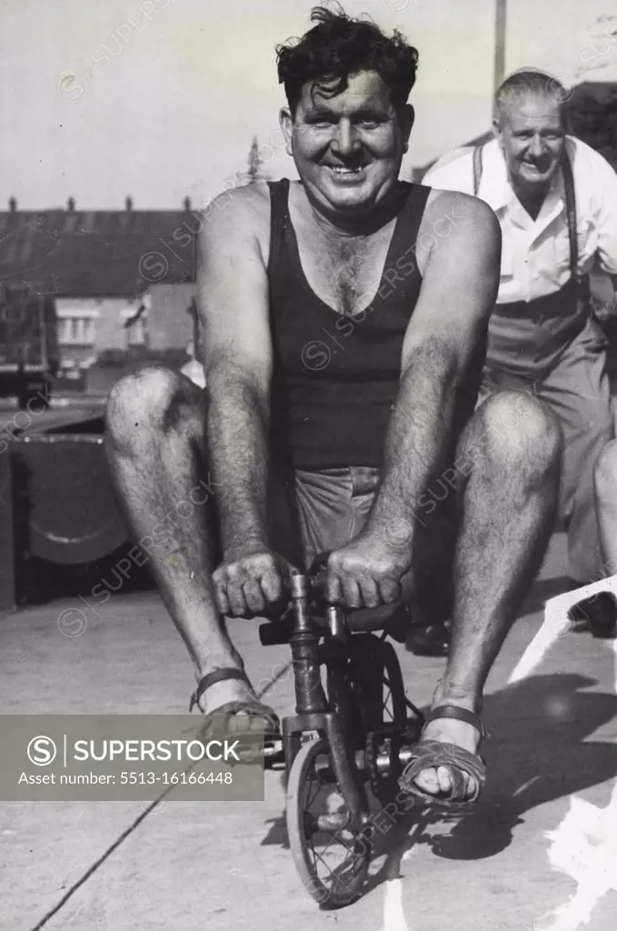 Publican George Lloyd training on a miniature bicycle for the publicans' Cycle Derby to be held at Sydney Sports Ground next Sunday. March 30, 1952.