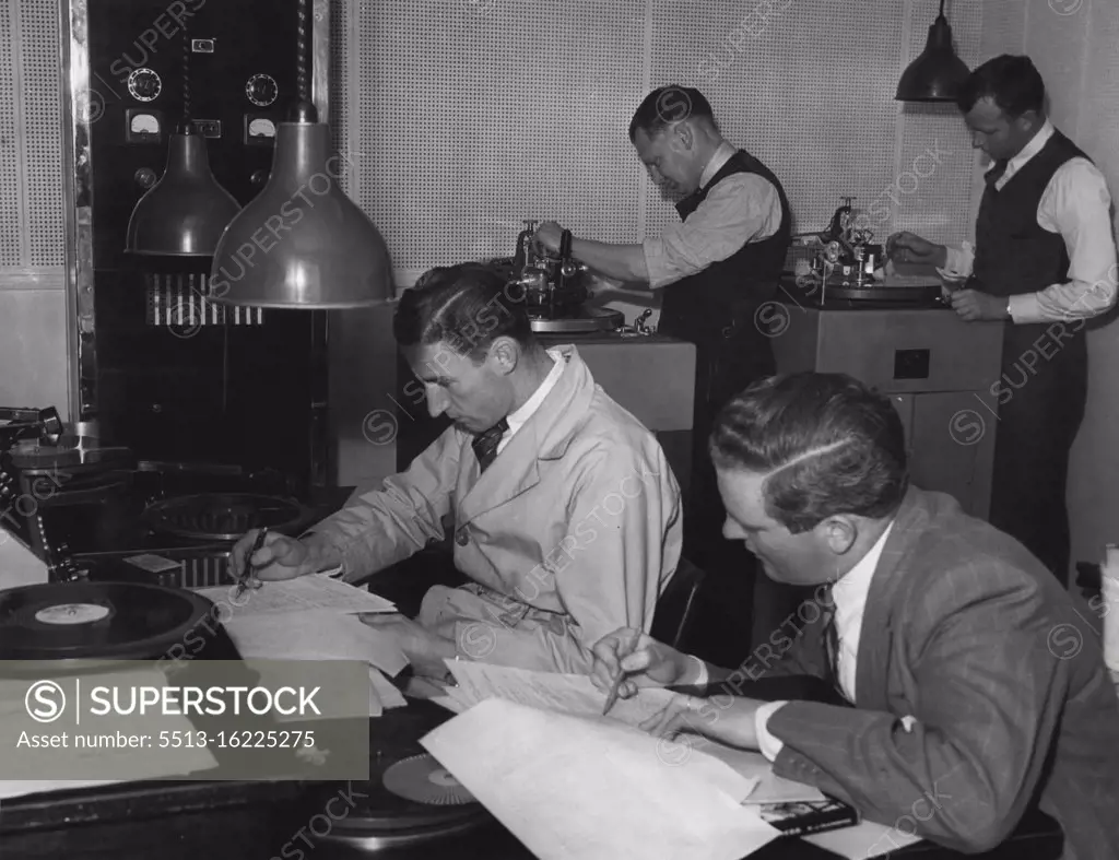 Finally record of episode is cut. Neville Merchant (L) Production Panel Operator puts in incidental music & sound effects while Producer Jacklin follows dialogue on script. In background actual cutting machines are in process of recording. Back left, Bill Dukes, technician, cuts acetate record while Engineer Burt Munnings cuts process record. November 4, 1944.