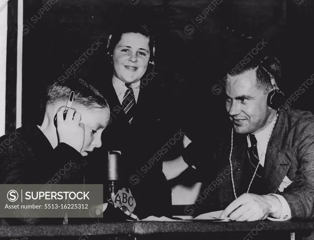 During the war the ABC was responsible for sending messages to Australian servicemen overseas and to the relatives of British children who had been evacuated to Australia to escape the German blitzkrieg. Here Jim Pratt helps two boys with the technicalities of a two-way radio-telephone conversation with their parents in England. January 1, 1941.