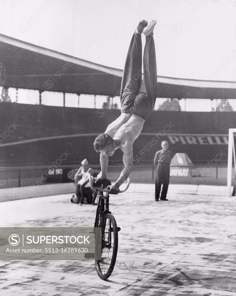 Going Around In Cycles - "Look, MA, No Feet!" Yugoslav cyclist Stanislav Vakulic does a variation of the no hands routine during the recent world cycling championships held near Rome. He works up a good pace and then stands on the handlebars and saddle on his hands. September 23, 1955. (Photo by United Press).