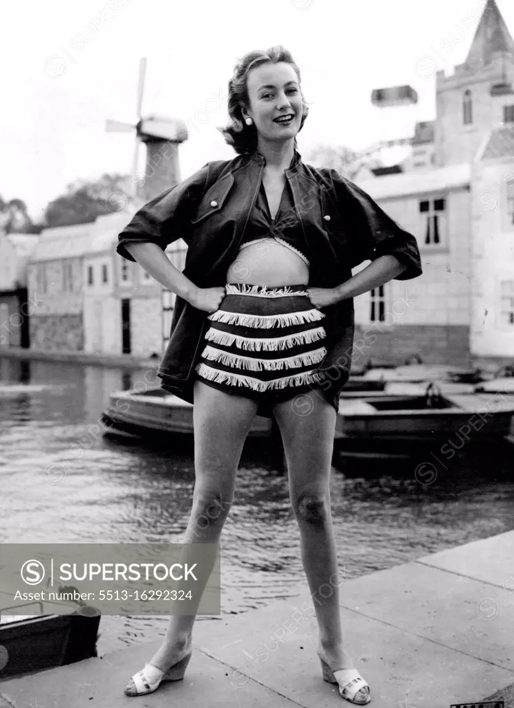 In The Red: A striking tires-piece beach outfit, in poppy red Sudan cotton, is worn at London's Festival Gardens by model jean Dawnay. The Square-cut Collis jacket has half- length sleeves, while white trimmings make a contrast to the tied an bra and matching red shorts. June 14, 1955. (Photo by Reuterphoto).