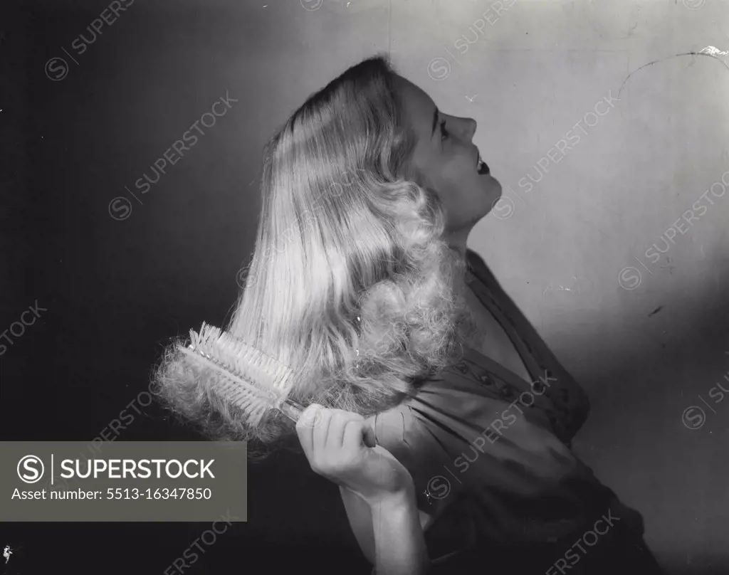 This girl is brushing her hair with a new all-around hairbrush, has already become very popular although only on the market for or so as yet. The handle of the brush is made of diamond-cut plastic; the bristles are nylon. January 14, 1947. (Photo by Hughes Brushes, Inc.).