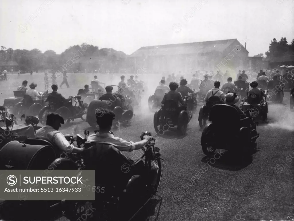 The Invalid Kick Up A Dust... Annual Tricycle Race At Richmond Park... The Grand Parade as seen through the fog of dust and exhaust fumes - and sunshine, during the annual Invalid Tricycle Race at Richmond Park, yesterday. July 25, 1949. (Photo by Associated Newspapers Picture).