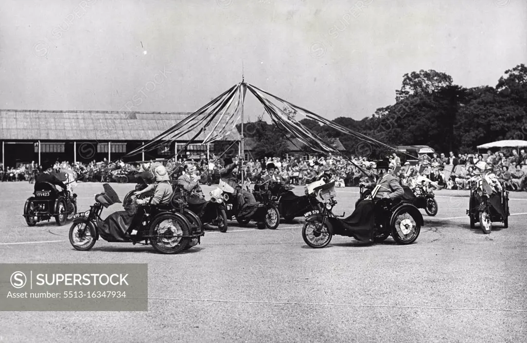 The "Festival Of Britain" event, group display, and here are seen the Surrey group, the winners, during their performance of the maypole. The Invalid Tricycle National Festival Rally was held today at the military camp, Richmond Park, Surrey. The "Festival Of Britain" event was sponsored by the "Daily Graphic". June 24, 1951. (Photo by S. L. Martin, Paul Popper Ltd).