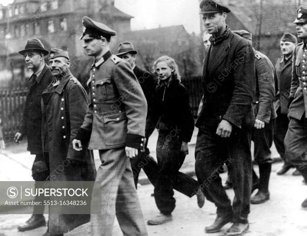 Volksturm and Civil Services Captured Girl among Prisoners : Volksturm, fire brigade, air raid wardens etc, being marched through the street of Hamborn (suburb of Duisburg). A girl was among the prisoners. May 29, 1945. (Photo by Sport & General Press Agency, Limited).