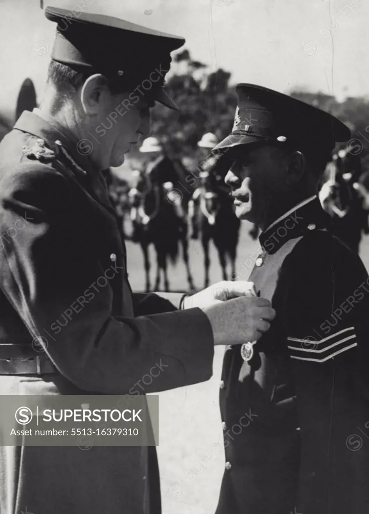 The governor lord Wakehard pinning king's police medal on breast of Sgt Tracker Alexander Relay. Sgt Reley is the first aboriginal police official to be so decorated. September 17, 1943. (Photo by Barry Newberry/Fairfax Media).