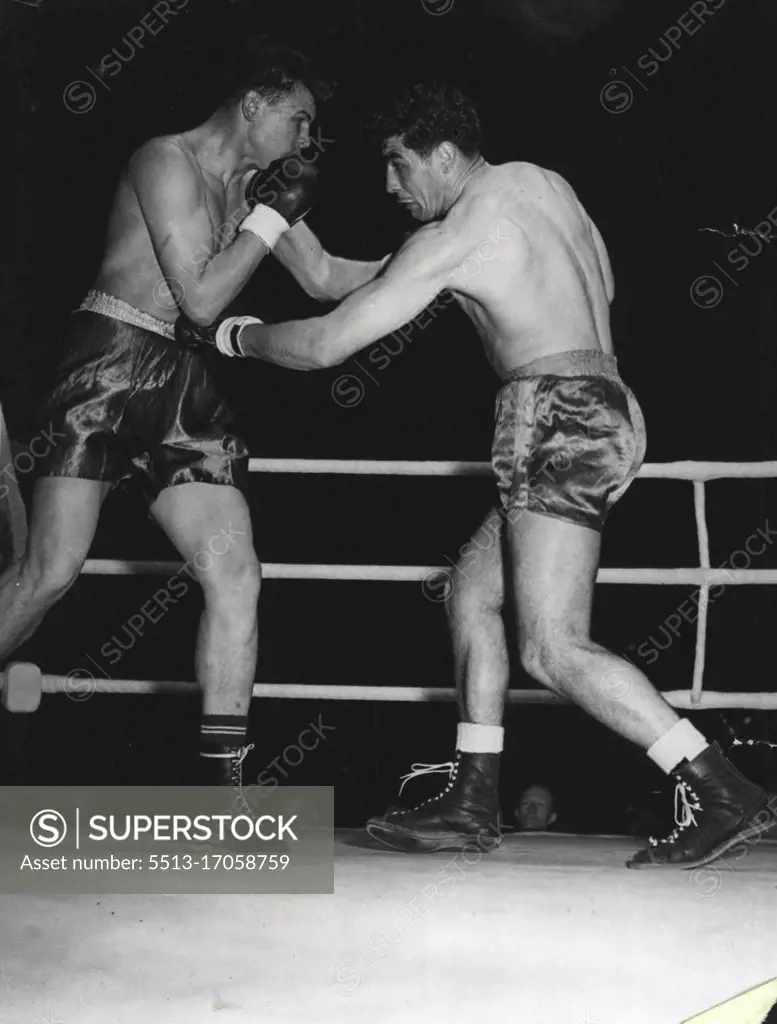 Boxing At White City -- Gardner on right gets home to Brions stomach in their fight at the White City last night. June 05, 1951. (Photo by Daily Mail Contract Picture).