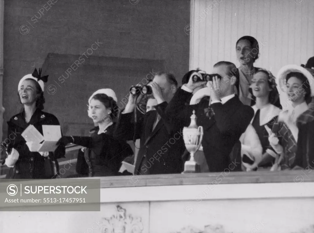 Binoculars In The Royal Box -- As the Queen points (second from left), the Dukes of Gloucester (centre) and Edinburgh follow the racing with binoculars from the Royal box at Ascot, Berkshire, this afternoon, June 18, the second day of the Royal Ascot meeting. Other in the box are unidentified. The Queen is dressed in black and wears a white hat. June 17, 1952. (Photo by Bippa).