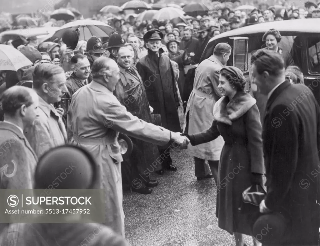 Royal National -- The Queen and the Queen Mother are welcomed by official as they arrive at a intree. The Queen and the Queen Mother made it a Royal occasion at Liverpool's famous Grand National on Saturday. They saw jockey Pat Taffe win on Quare times for woman owner Mrs. Cecily Welman. March 26, 1955. (Photo by Daily Express Picture).
