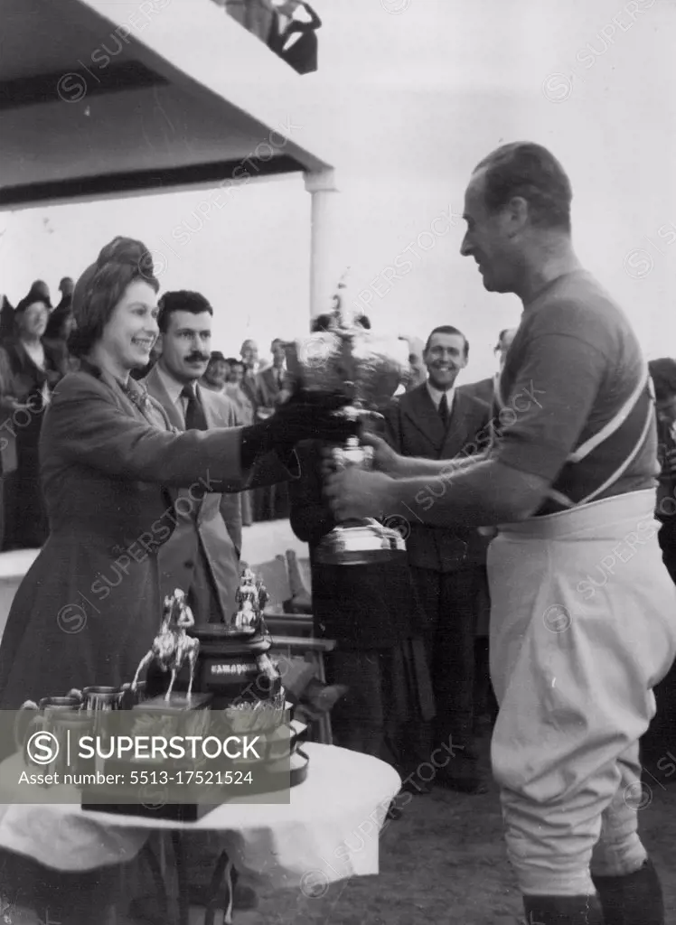 Princess Presents Polo Cup - Princess Elizabeth presents the Cownpore Polo Cup to Lord Mountbatten, Captain of the Shrimps team which beat the Saints in the final for the cup at Marsa, Malta December 2. December 06, 1949. (Photo by Associated Press Photo).