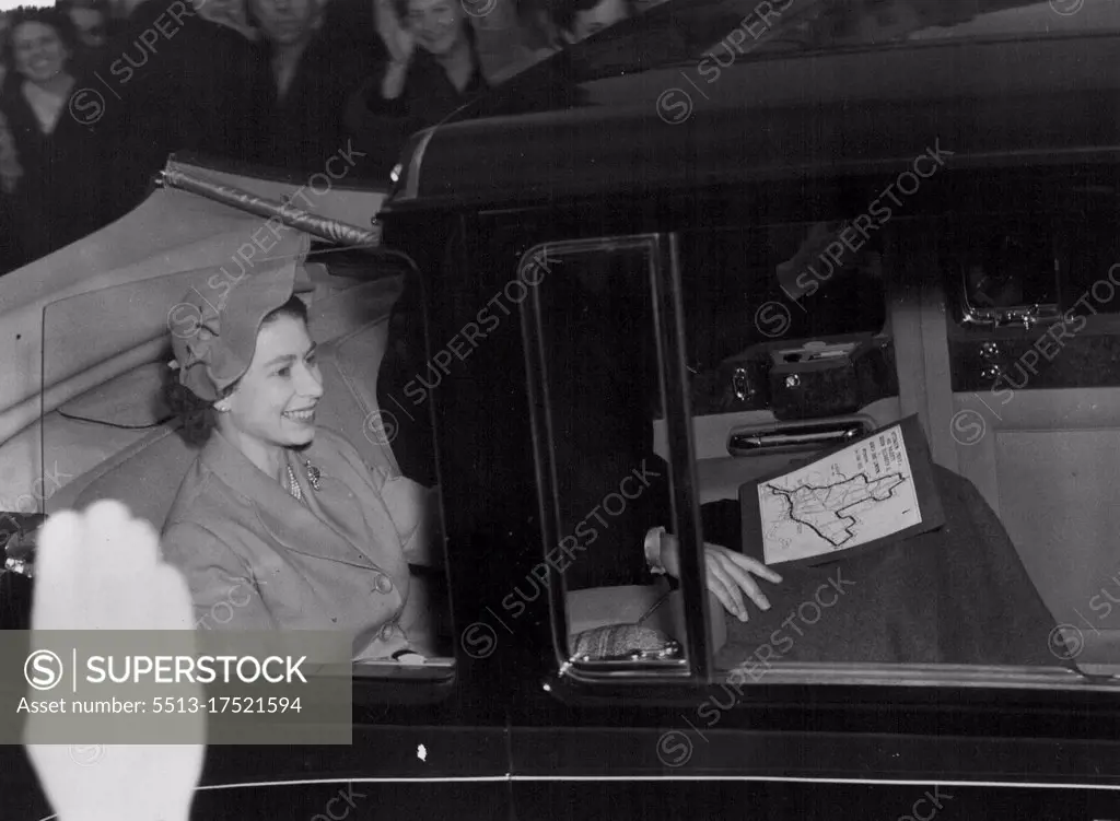 The Queen smiles as the crowds wave and cheer during the Queen's first Coronation drive through the London streets. The Royal Couple followed the route with the aid of a map seen on the Duke of Edinburgh's lap. June 03, 1953. (Photo by Daily Mirror).