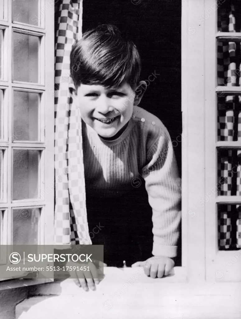 Happy Prince -- This happy picture of Prince Charles was taken by Royal photographer Lisa, as the young Prince looked out from the kitchen window of the Welsh House at Royal Lodge Windsor. April 22, 1954. (Photo by Paul Popper Ltd.).