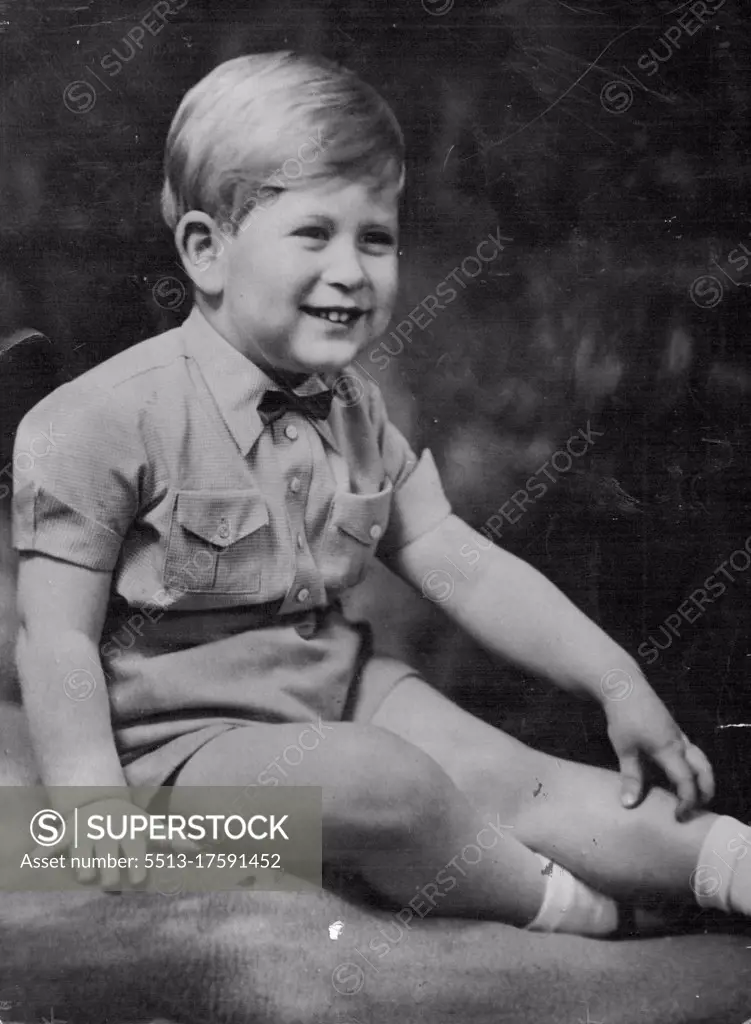 Prince Charles, dressed for a State occasion, wears a romper suit and an American-style bowtie. He is fair-haired, blue-eyed. Prince Charles... in baby bow tie, double breaster. Bow ties are smart for boys, as Prince Charles shows here. He wears this one with check romper suit. March 24, 1952. (Photo by The Associated Press Ltd.).