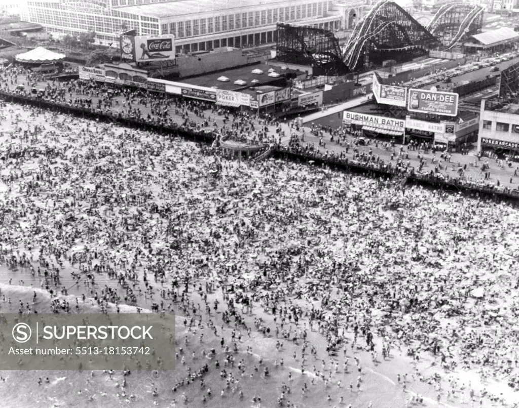 Sun And Lotion Are Popular Here - Here is an aerial view of Coney Island as Sunday temperature hit a scorching 86.4 and almost a million people jammed the popular bathing spot seeking relief. June 25, 1951. (Photo by AP Wirephoto).