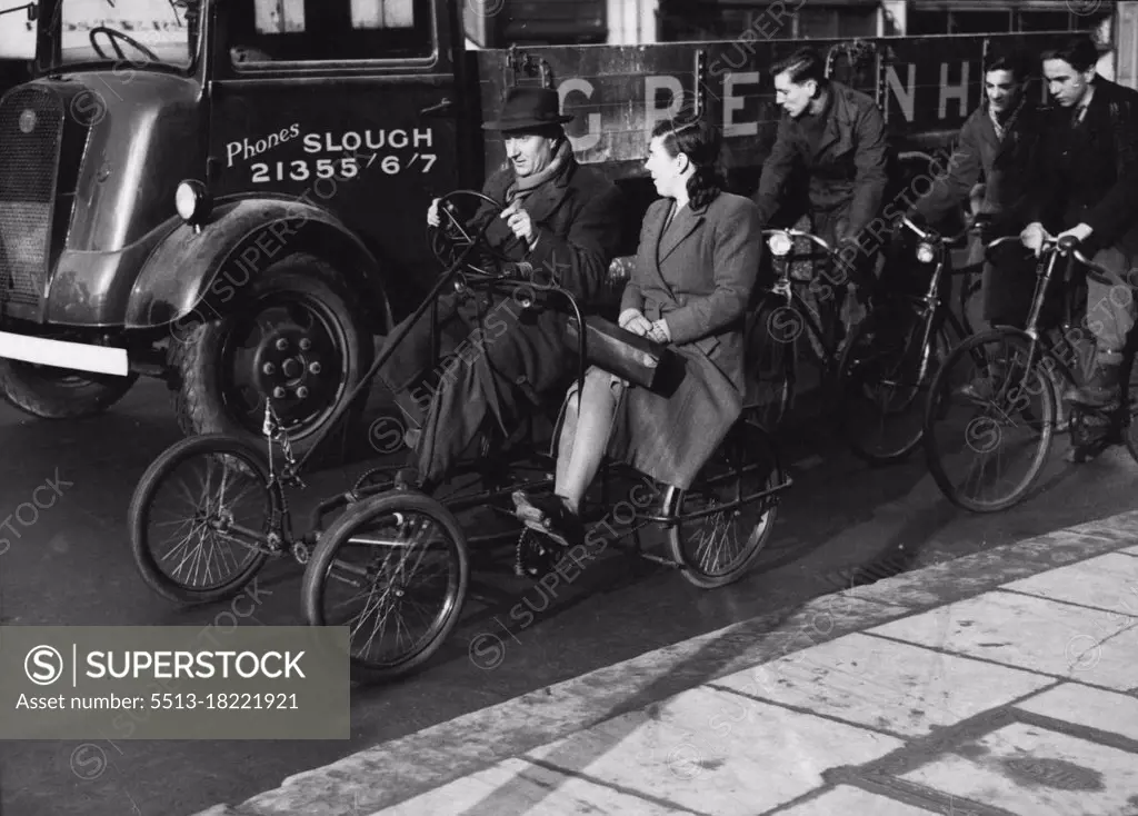 Keeping Warm - And Going Places.Mr. Vincent Topham on what he calls his "Winter Warmer" bicycle which he invented. His home is in Albert-street, Slough.The Cycle has pedals for two, and while one pedals, the other has time to rub his hands to keep warm. March 19, 1946.