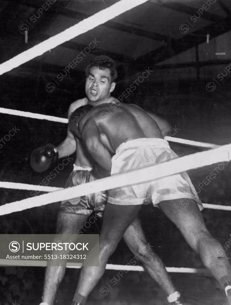 Dave Sands about to let go a jolting right as Boy Brooks covers up in the third round of their Singapore fight. Brooks didn't answer the bell for the fourth round.Triple Champion of the Orient, Boy Brookes didn't last long when he met Sands at Singapore. Sands won easily in three rounds. May 29, 1952.