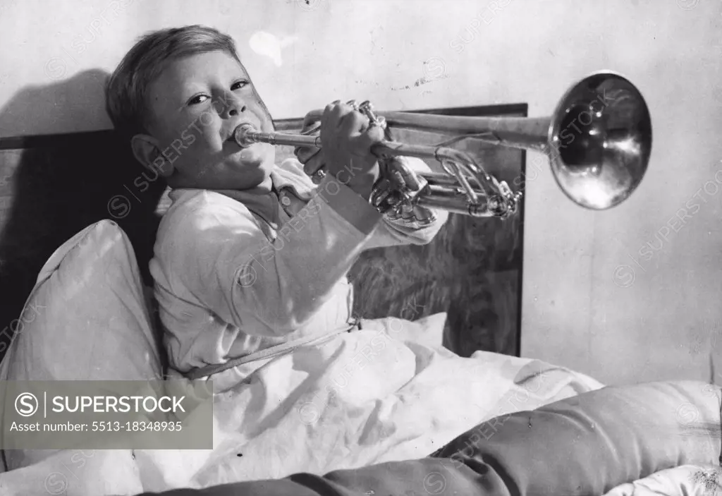 Young Man With A Horn -- A puffy-cheeked young man with a £22 silver trumpet may some day be the successor of Louis Armstrong and Harry James. He is 4-year-old Roger, son of Mr. and Mrs. Thomas Sawell of West Wickham, Kent -- pictured here in his bed, blowing high hard 'early morning' notes on his shiny instrument, as he does every morning at six o'clock. Mr. and Mrs. Sawell don't find it necessary to set their alarm clock. Roger has been blowing the trumpet since he was two years old, and his music teacher, Mr. E.G. Moss, ***** he can already play nearly as ***** as most youths of twenty. November 30, 1949. (Photo by Reuterphoto). 