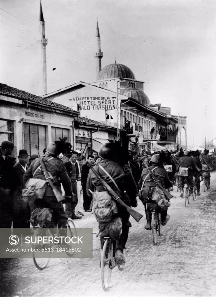 Latest Pictures of Italian Troops In Albania.Steel helmeted members of the famous Italian Bersaglieri their helmets decorated with the familiar cock's feathers, photographed as they cycled into Scutari, town in the north of Albania. The inhabitants watch their entry silently by the roadside. April 14, 1939. (Photo by Keystone).
