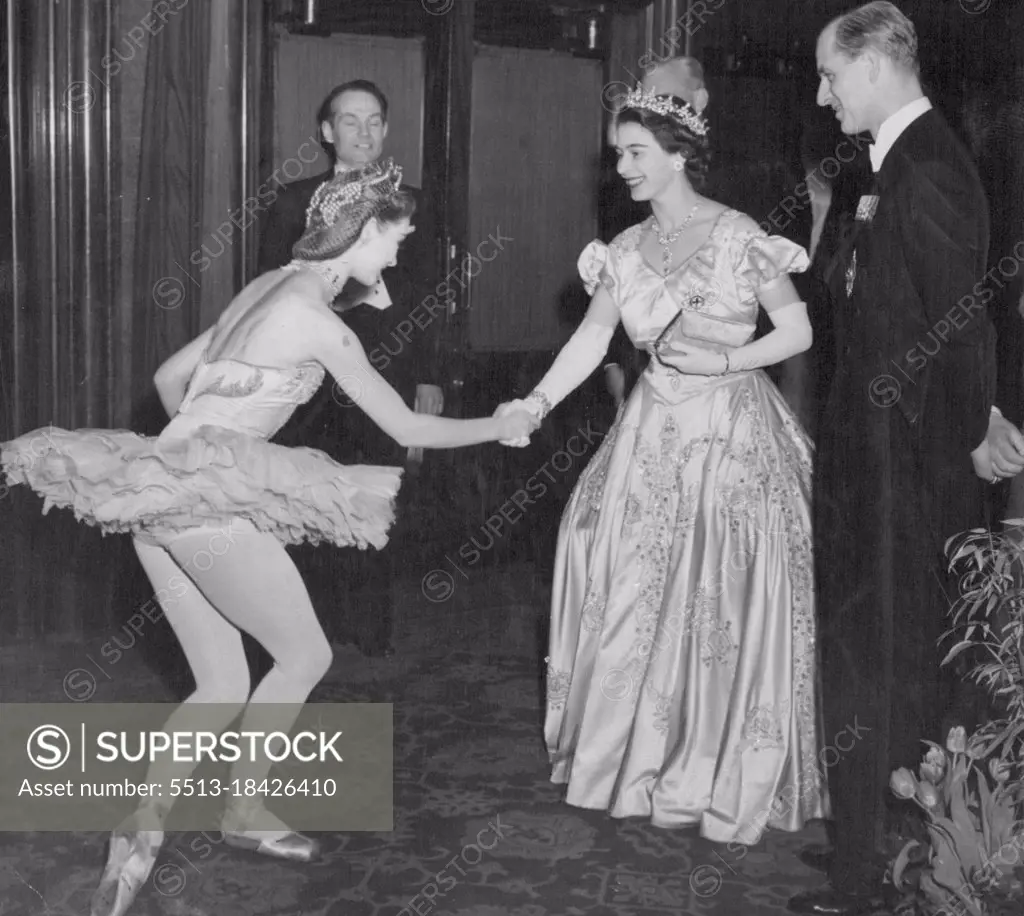 Princess And The Ballerina -- Princess Elizabeth, watched by the Duke of Edinburgh, smilingly congratulates Moira Shearer, the scouts ballerina, after a concert given in their honour at the Usher Hall here. The Princess wears a Crinoline gown of white satin embroidered with crystals, a diamond tiara and necklace. Earlier, the Duke of Edinburgh had received the freedom of the city at a ceremony in the Usher Hall. March 02, 1949.
