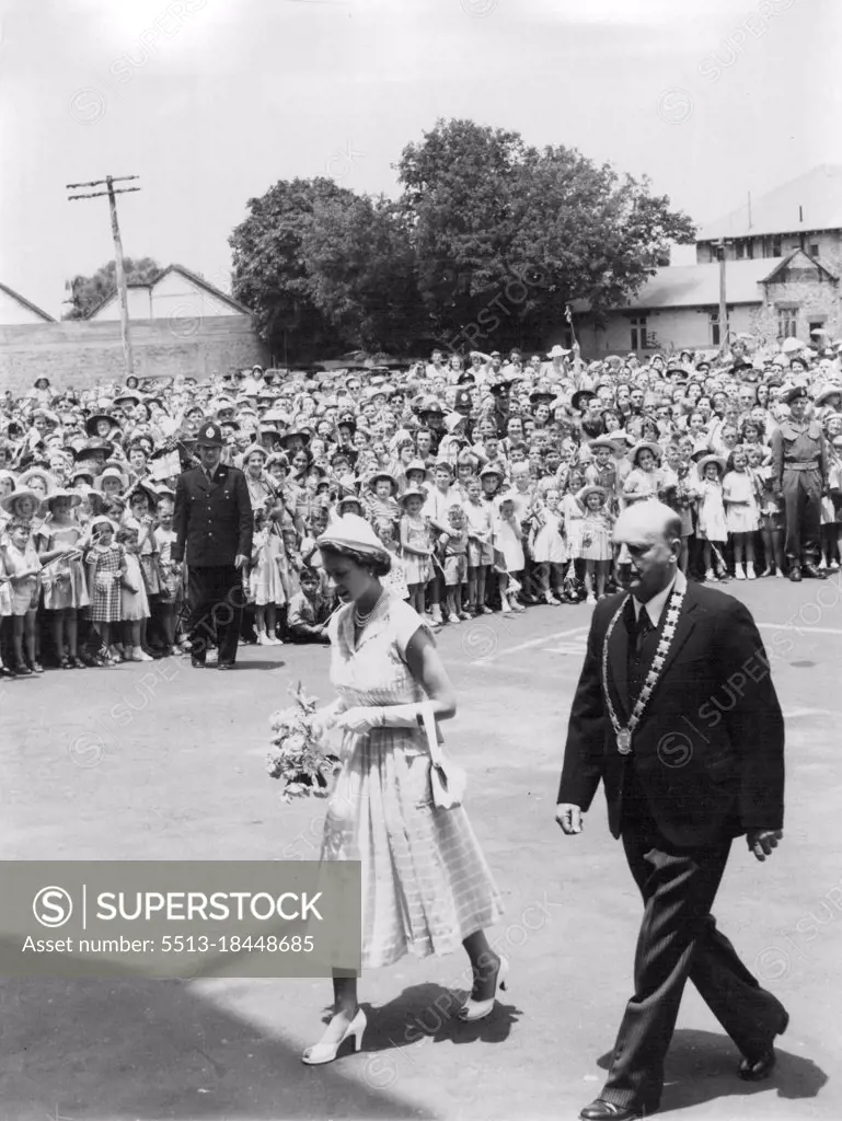Queen Elizabeth with the Mayor, Dr. H. G. Tod, walking through the guard of honor of Boy scouts and Guides at the public welcome at Cambridge, New Zealand. January 13, 1954.