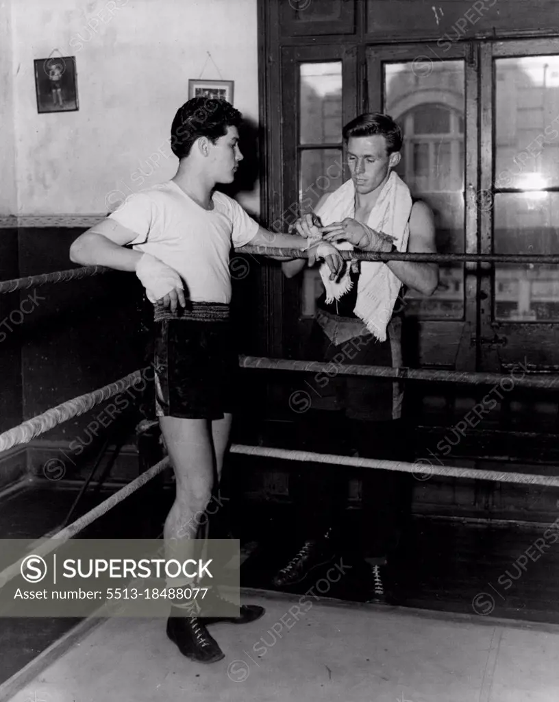 Charlie Dunn who meets Ray Fitton at the Stadium on Monday night in an earlier picture with worlds Champion Jimmy Carruthers. June 15, 1953. (Photo by Phil Ward Studios).