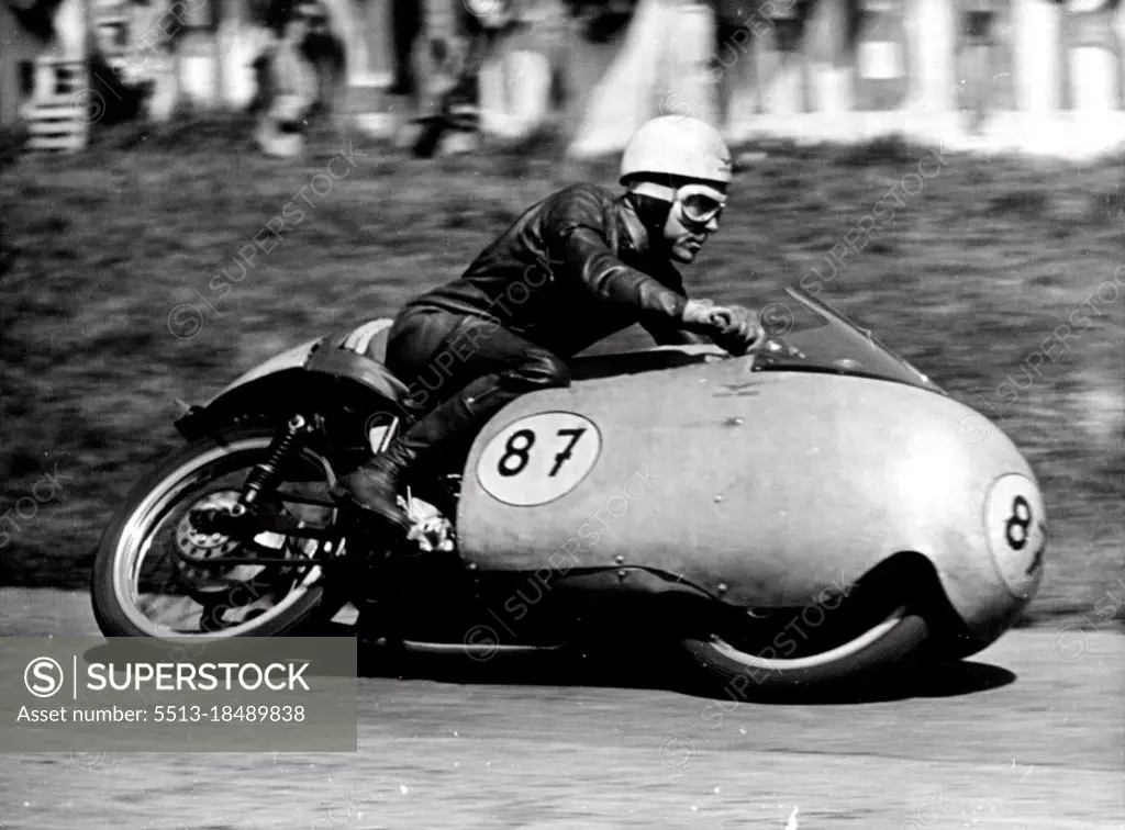 Duke Does It Again -- Australia's Ken Kavanagh at speed during the 350 CC Rave which he won on his Moto-Guzzi.Geoff Duke, Britains world 500 CC Motorcycle champion robe his 500 CC Gilera to Victory in the Rhine cup races at Hockenheim. Germany on Sunday.More than 120,000 fans saw him set up a lap record of 123.8. miles an hour, he covered the 20 laps in 47 minutes 12.5. seconds.Ken Kavanagh of Australia was second in this event and also won the 350 CC race on his Moto-Guzzi at 11.84 miles an Hour. May 10, 1955. (Photo by Paul Popper Photo, Paul Popper Ltd.).