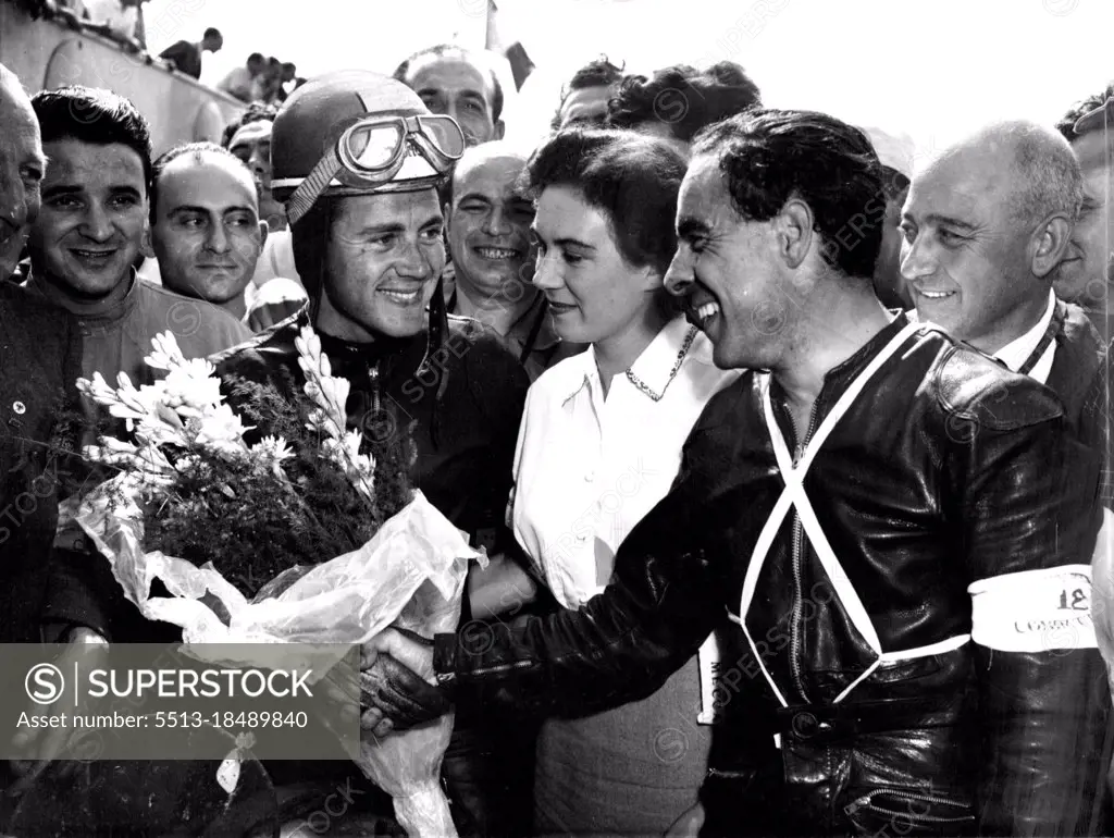 Duke Wins At Monza -- Ken Kavanagh (right) of Australia Congratulates Britain;s Geoffrey Duke, after the latter had won the 350 CC Motorcycle event of the grand Prix  Des Nations At Monza, Italy, September 9. Kavanagh was second, Both were riding Nortons.Britain's Geoffrey Duke, riding a Norton, won the 350 C.C. Motorcycle event in the grand Prix Des Nations At Monza, Italy, September 9. Second was Australian Ken Kavanagh, and Jack Brett, of Britain, was Third. Both the latter rode Norton. September 25, 1951. (Photo by Associated Press Photo).