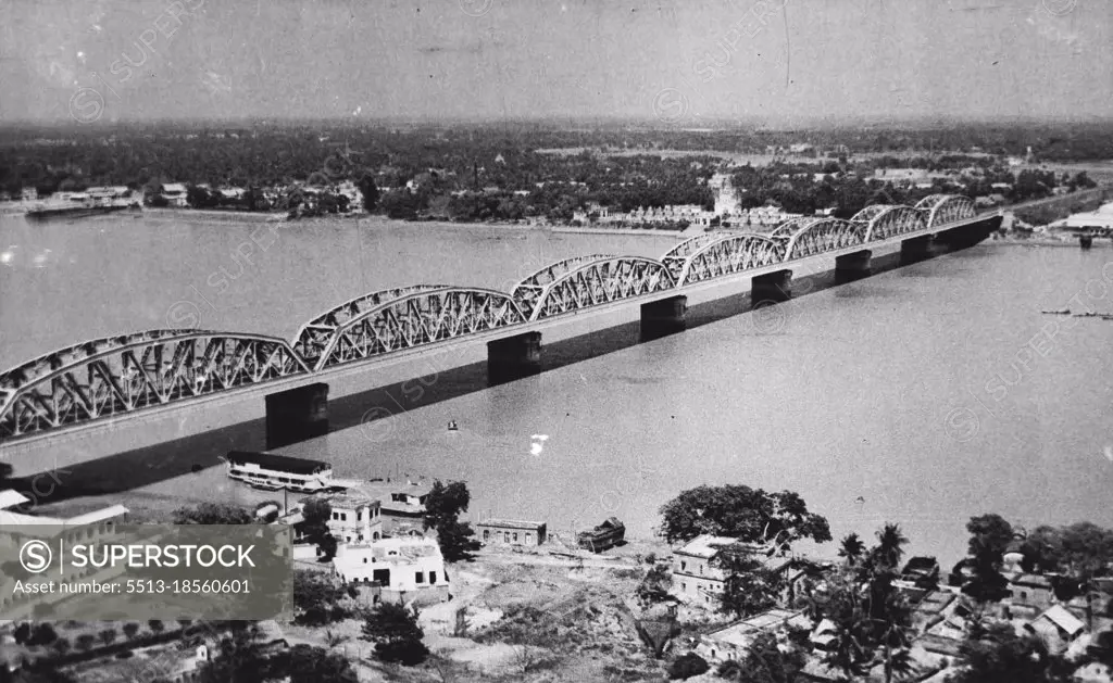 "Calcutta" an aerial view of the Willingdon Bridge, just outside Calcutta which spans the stretch of water on the River Hoogly on which B.O.A.C. Speedbird flying boats alight enroute to the Far East and Australia. The houseboat beneath the first span of the bridge is where passengers are refreshed. July 8, 1947.
