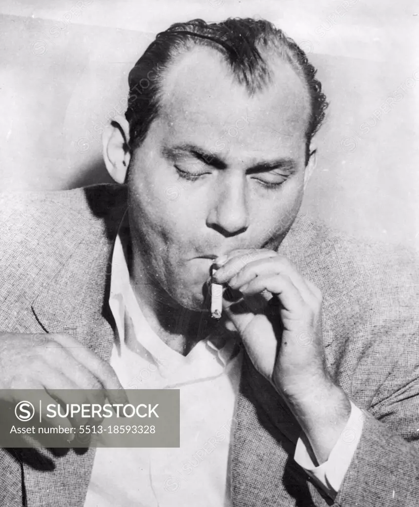 Kidnaper Puffs Cigarette - This is a closeup of Carl Austin Hall, 37, as he nervously puffs on a cigarette while being questioned in connection with the kidnapping and murder of Bobby Greenlease at Newstead police headquarters today.Kidnapper and murderer, Carl Austin Hall. October 07, 1953. (Photo by AP Wirephoto).