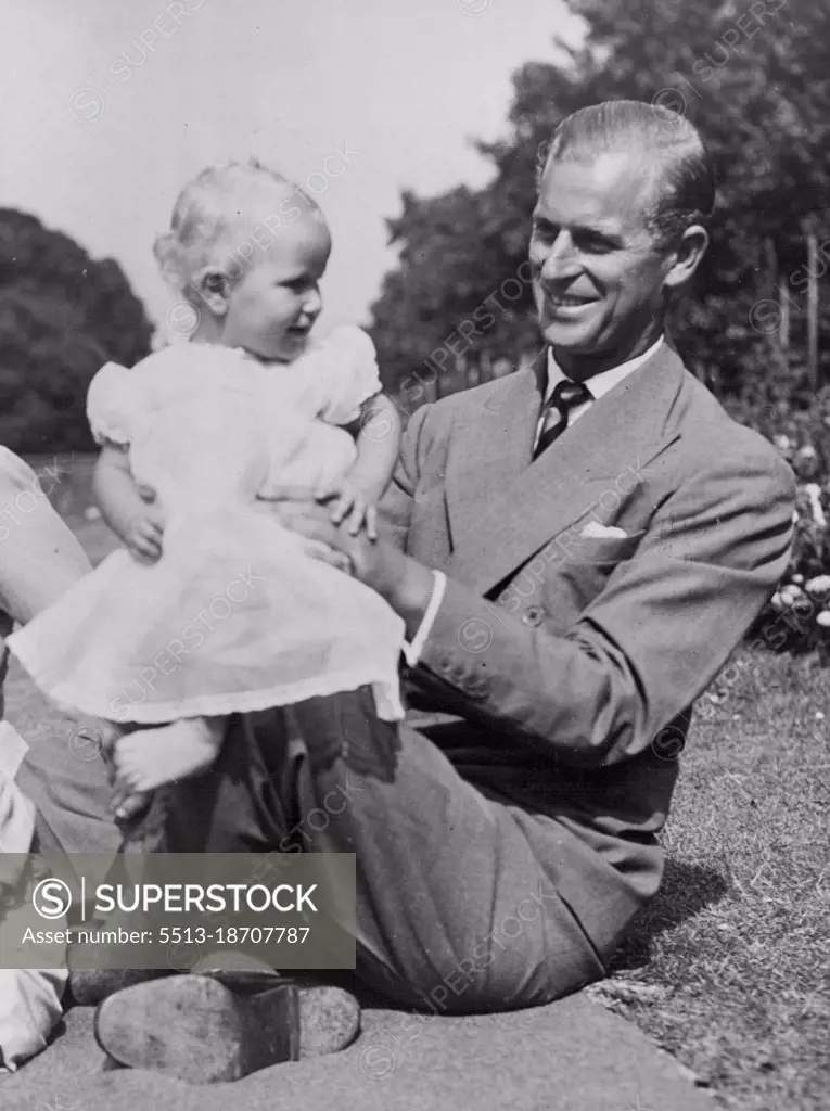 A Happy Family In Their Garden -- The Princess Anne bounces happily on her father's knee.Picture just released show H.R.H. Princess Elizabeth and the Duke of Edinburgh with their children Prince Charles and Princess Anne in the garden of the London Home Clarence House. August 09, 1951. (Photo by Barratts Photo-Press-Agency)