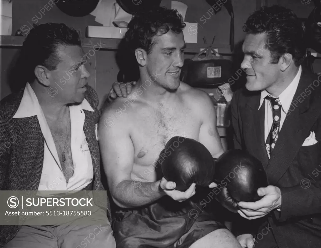 When Fishers Meet - Billy Conn (center), chats with middleweight Mickey Walker (left), and Freddie Mills (right), British light heavyweight champion, in a dressing room at his training camp in Greenwood Lake, N.J., June 12, where he is in training for his forthcoming bout, June 19, with Joe Louis. June 12, 1946. (Photo by Associated Press Photo).