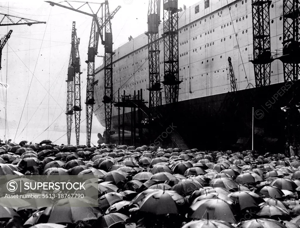 Launch Of The "Queen Mary" -- General view showing part of the huge crowd, under umbrellas, watching the launch of the "Queen Mary". September 26, 1934. (Photo by Keystone).