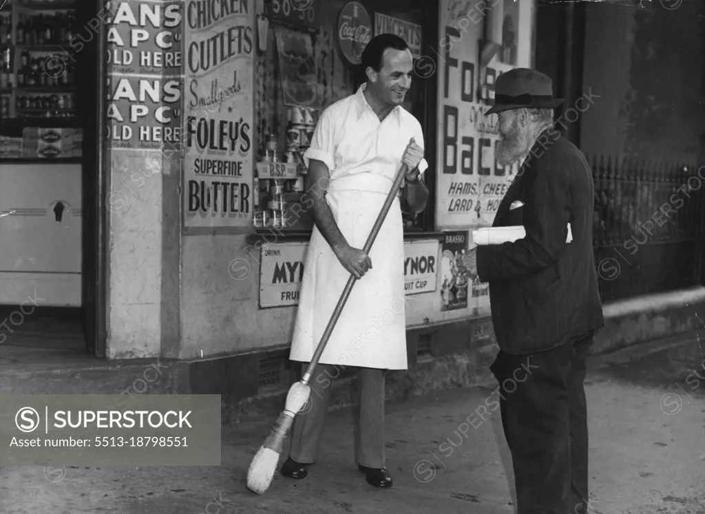 Early astir, this bearded old man stopped to chat about the wet morning while Lane was sweeping the footpath outside the shop. February 14, 1948.