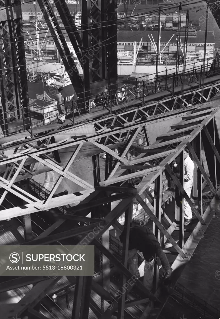 Like Busy spiders in a Huge steel web, the team of painters on the bridge climb Nonchalantly about as they work. February 01, 1951.