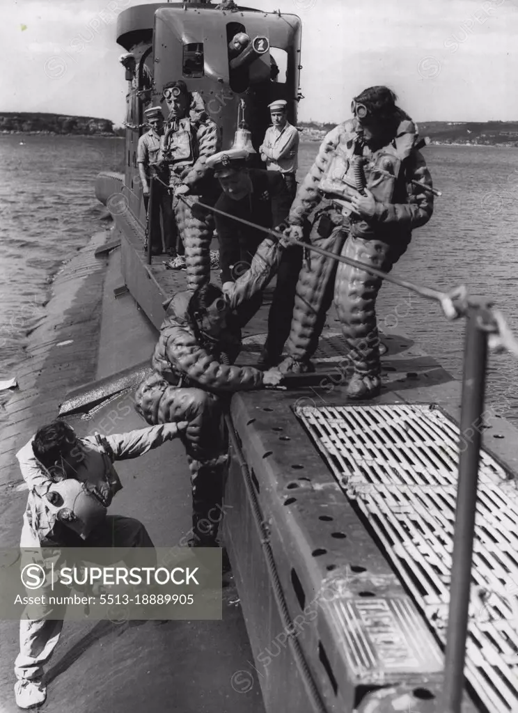 HM Submarine Tactician prepares for ocean voyage to Fiji & New Zealand for exercises with the RNZN & RNZAF.Testing their escape equipment prior to leaving Sydney tonight. (Tues) These crew members under the instructions of C.P.O Coxswain. A. MacLean on the submarines side.Watching L/S. I. Gill, P.O. L. O'Gara.. & M (E). I. C. Rayment.The Tactician is one of three submarines on loan to the Royal Australian Navy and has been engaged in exercises with our squadron.They can stay afloat for over a week in one of the *****. November 02, 1955. (Photo by Gordon Herbert Short/Fairfax Media).
