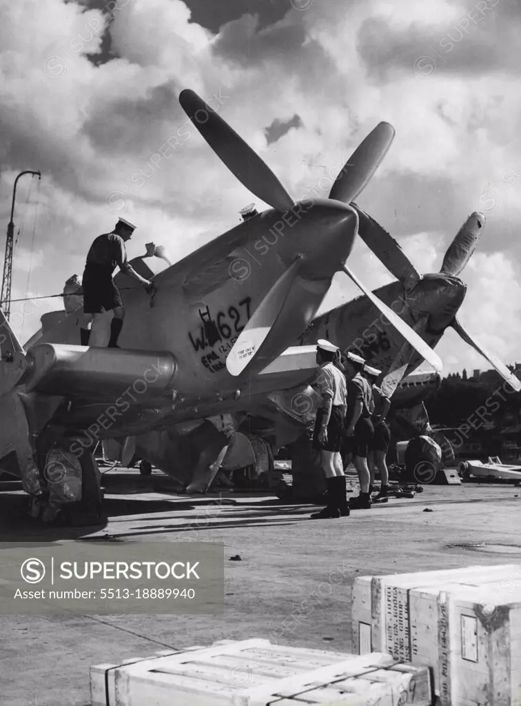 Aircraft handling crew of the carrier "Vengeance" preparing to unloading planes from two flights deck along garden Is. March 12, 1953. (Photo by Winton Irving/Fairfax Media).