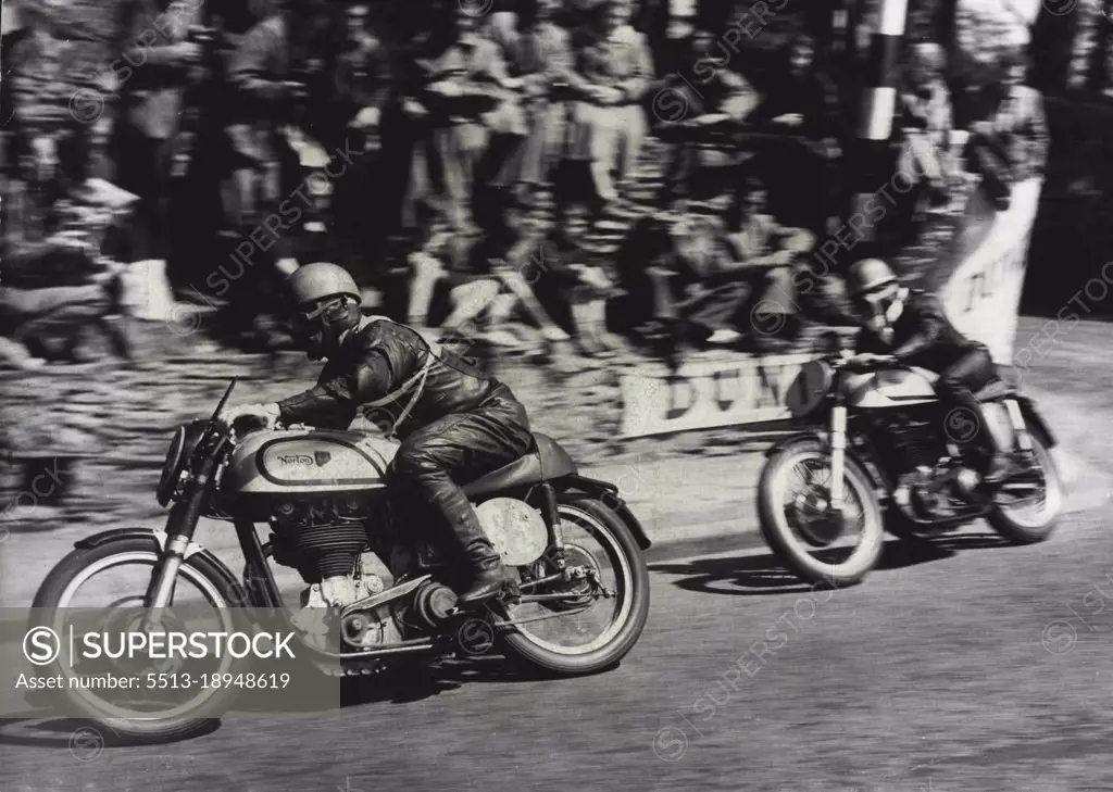 Motor Cycling "Duke" Wins Isle Of Man Race -- Geoffrey Duke riding a Norton (No.1) catching up on T. McEwen (also on a Norton) (No. 85) around the sharp corner at Governor's bridge during the race.Geoffrey Duke - "The Duke" of motor cycle racing - won the Senior International Tourist Trophy Race in the Isle of Man yesterday and smashed all his own records - by mistakes. On his second circuit of the course he misread a signal and thought he was lying third. He "burned up" the last 13 miles of the 38-mile course, touching 130 miles perhour and raised his lap record form 93.53 miles per hour to 95.22. June 9, 1951. (Photo by Paul Popper).