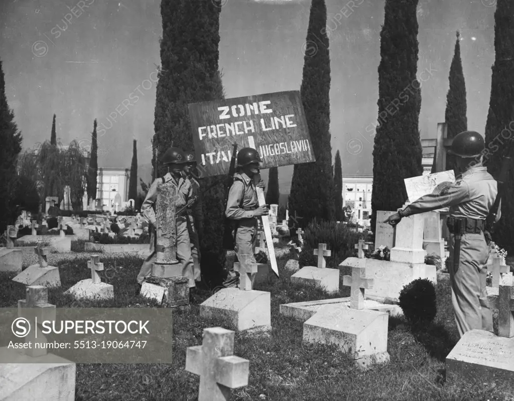 Marking New Italic-Yugoslav Boundary -- Soldiers place a marker in a cemetery on the outskirts of Gorizia, divided by the French Line, September 10. At this point, near Gorizia, Venezia Giulia, West of the "Morgan Line" that the Anglo-American and Yugoslav occupation areas of the once completely Italian province of Venezia Giulia, were divided.Graves in foreground are thoge of Italian soldiers who died in World War II.Soldiers in picture are from 350th Infantry Regiment, U.S. 88th Division. When instruments of ratification of the Italian Peace Treaty are deposited in Paris, September 15, all British and American Troops will man their new frontier. September 13, 1947. (Photo by Associated Press Photo).