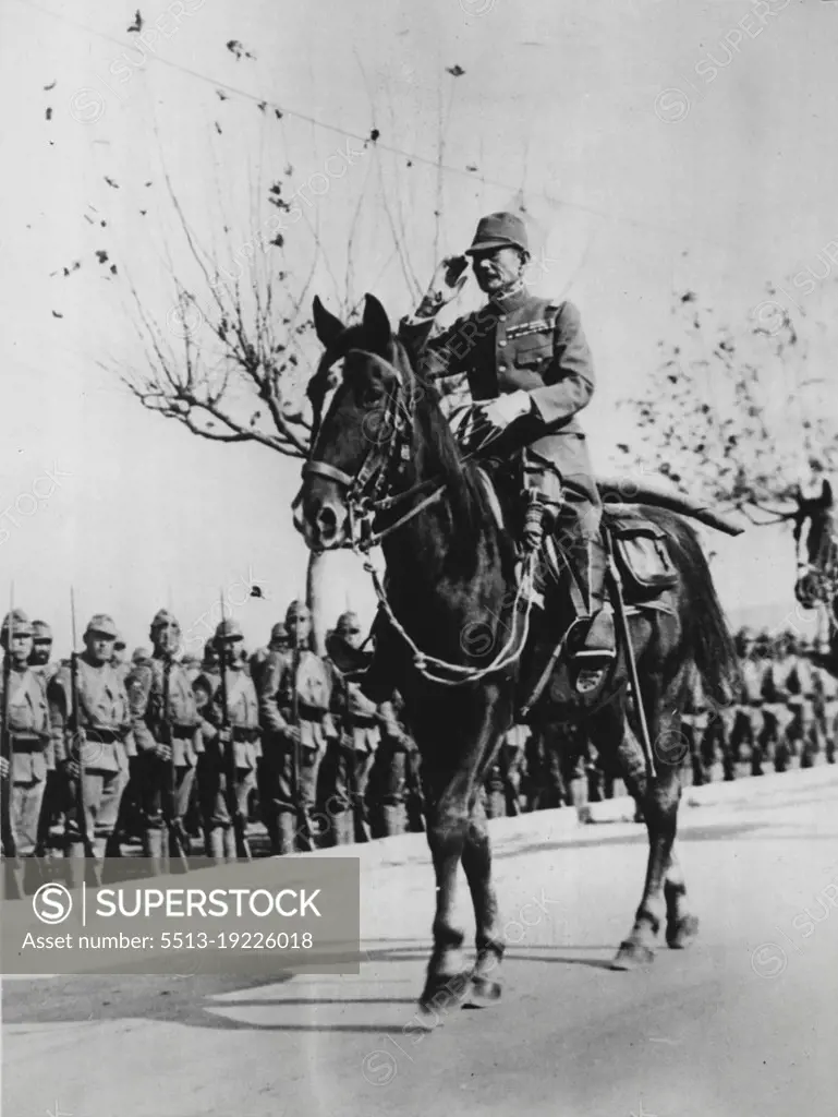 Japanese Commander Enters Nanking -- Gen. Iwane Matsui, highest in command of the Japanese armies in the Nanking-Shanghai area, salutes his victorious troops as he enters the walled city of Nanking through the Chungshan gate. August 1, 1938. (Photo by ACME Newspapers Inc.).