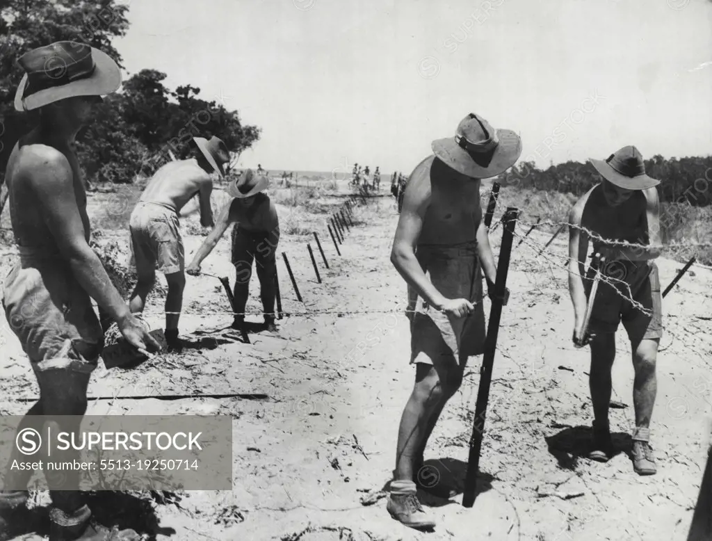 Diggers carry out a dull, tough but vital job in harsh conditions.Our forces in around Darwin working in extreme heat are fixing mules of ***** war defences. January 02, 1942.