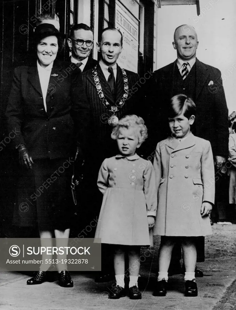 Prince And Princess Leave Ballater Form London -- Prince Charles and his sister, Princess Anne pose for their photograph at Ballater station, Scotland, May 18th, before entraining for London after a holiday at Balmoral. At left is nurse Lightbody. Other persons not identified. November 15, 1954. (Photo by Associated Press Photo).