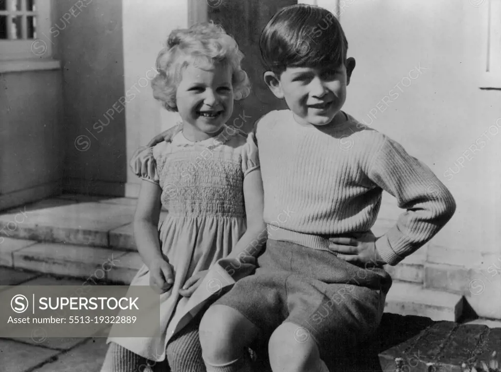 Royal Children At Windsor Lodge -- Hitherto unpublished picture of the Royal Children, Prince Charles and Princess Anne, photographed as they sit together on the low wall of the little Welsh House at Royal Lodge, Windsor. August 18, 1954. (Photo by Paul Popper, Paul Popper Ltd.).