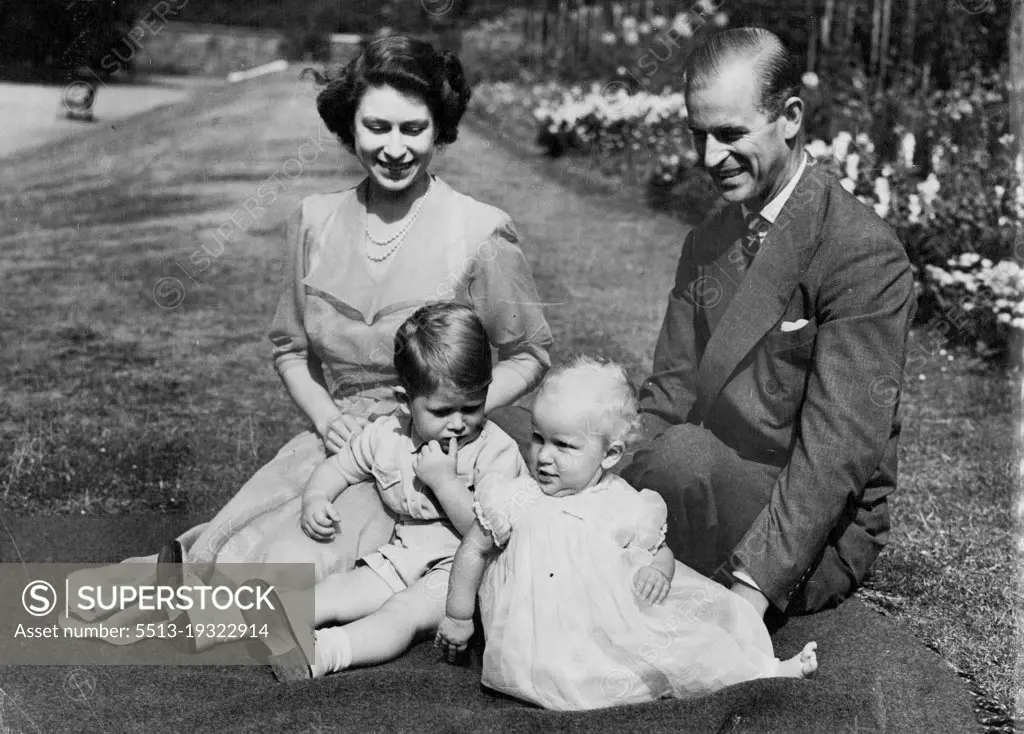 A Young Royal Family At Home -- This group, by our Cameraman Stanley Devon, was taken on the lawn in the gardens of Clarence House, the Royal Couple's London Residence.One of the busiest and hardest-working young couple in the World are Princess Elizabeth and the Duke of Edinburgh.After his return on July 21st from naval duties in the Mediterranean, the duke was immediately plunged into a round of official functions in Britain. Then on September 25 the Royal Couple will leave on a visit to Canada where they will spend several weeks as guest of the governor-general, viscount Alexander. As a conclusion to their travels on the American continent, they are to spend October 24th and 25th at the white house as guests of President Truman. August 09, 1951. (Photo by Paul Popper).