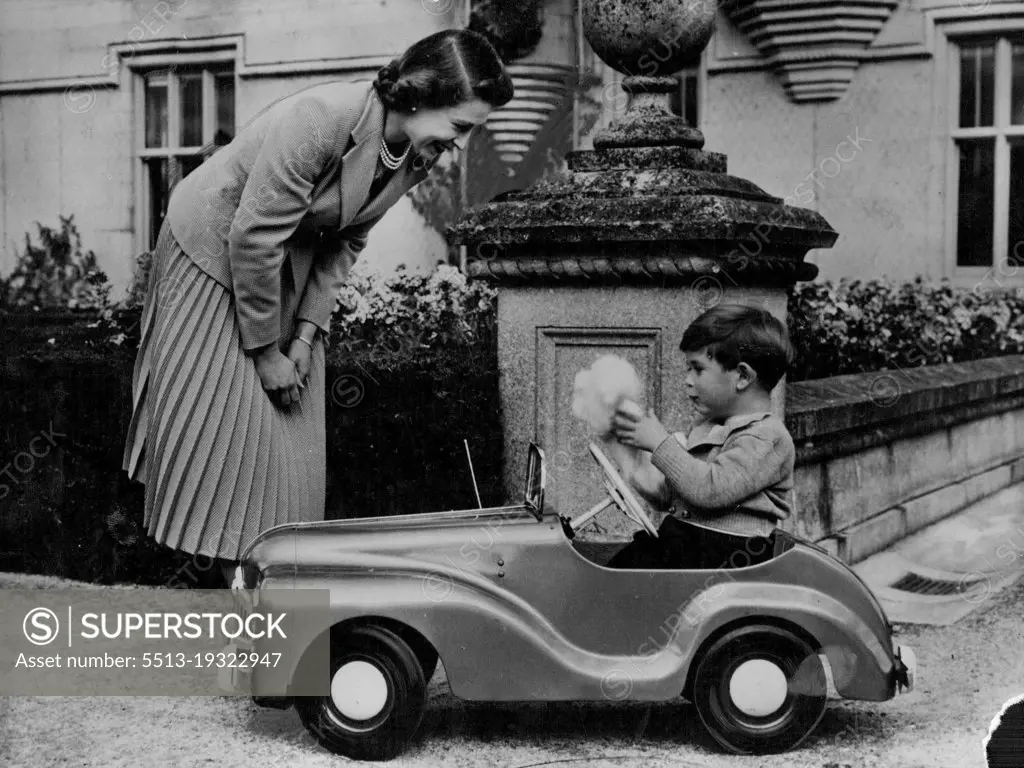 Prince Charles Is Four Today :This delightful mother and child study shows the Queen watching Prince Charles play with a glove puppet in his toy car in the grounds of Balmoral Castle.It was made specially to commemorate Prince Charles' Fourth Birthday Anniversary on November 14.This is the pedal car that is Prince Charles' greatest delight. The car is not elaborate, but has lights and a dummy radio mast. December 24, 1952. (Photo by Associated Press Photo).