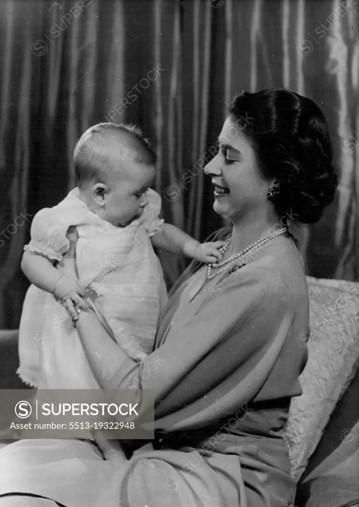 H.R.H. Princess Elizabeth And Prince Charles :First informal photograph of H.R.H. Princess Elizabeth at play with her infant son. The picture was taken in Princess Elizabeth's private sitting room at Buckingham Palace. Her Royal Highness is dressed in dove-grey. April 9, 1949. (Photo by Baron, Camera Press).