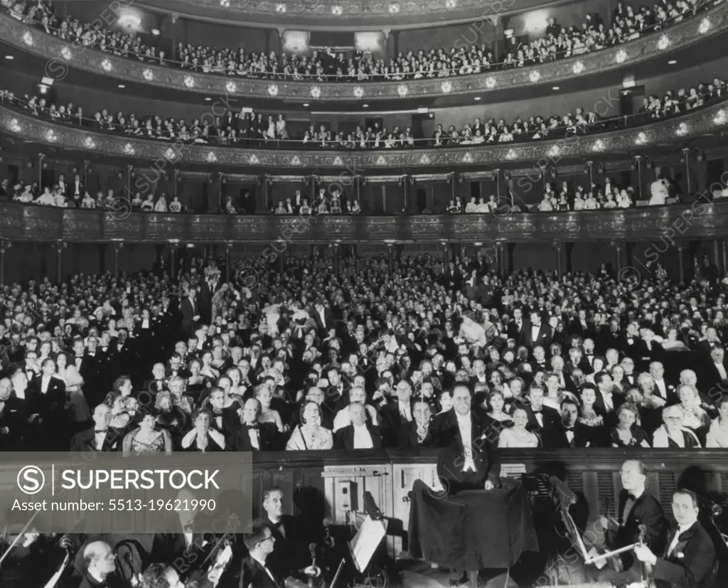 Metropolitan Glitters On 70th Anniversary -- Here's a general view of interior of Metropolitan Opera House here tonight as audience awaits second act curtain of Gounod's "Faust". Opening was the 70th anniversary of the famed music centre. Conductor Pierre Monteux right center foreground, raises baton to ring up the curtain. November 16, 1953. (Photo by AP Wirephoto).