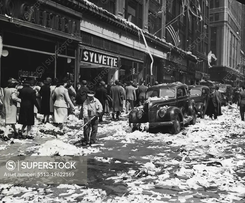 Aftermath -- ****** Sixth-street and Sixth-avenue, New York City, presented a problem to the lone street cleaner of clearing away paper tossed about by merrymakers celebrating the end of the war in Europe. July 5, 1945. (Photo by Associated Press Photo).