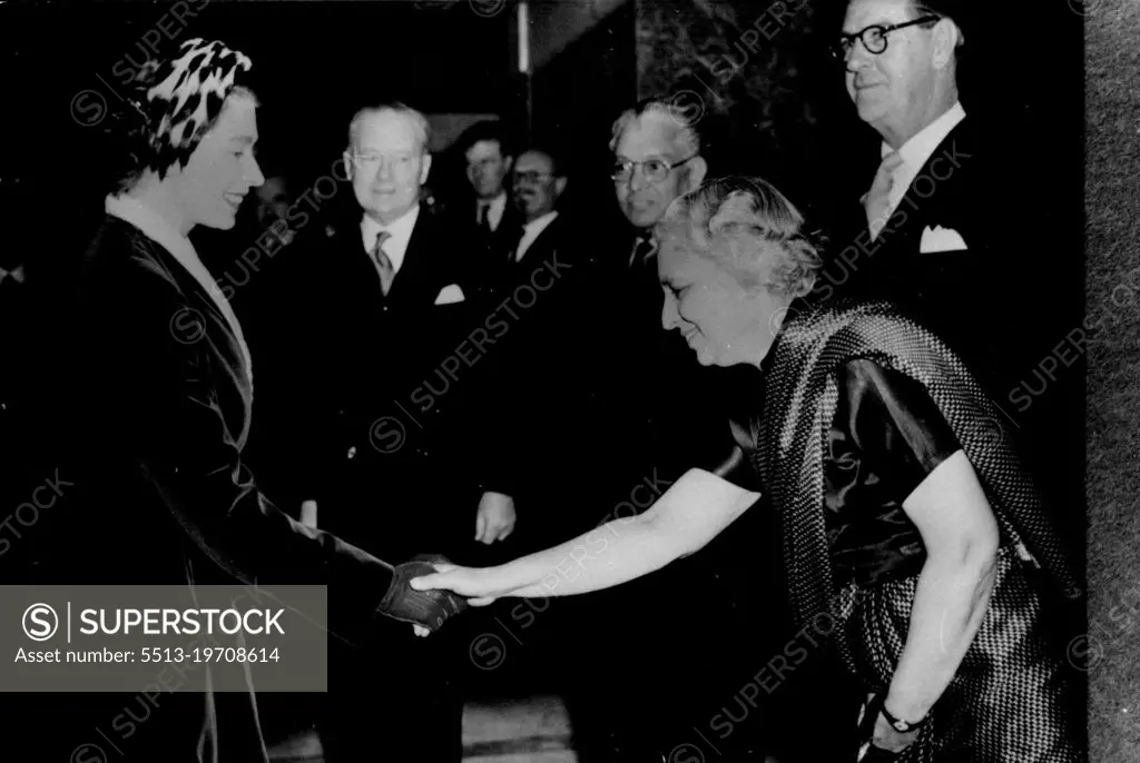 The Queen Meets Mrs. Pandit.H.M. Queen-Elizabeth shaking hands with Mrs Pandit, Indias High Commissioner in London, when she attended a reception given by the Dominions Fellowship Trust at the Goldsmiths Hall, London. In background are seen Sir Thomas White, H.C. for Australia: Sir Claude Corea, Ceylon and Mr. J.P. Jooste, South Africa. March 16, 1955. (Photo by Sport & General Press Agency Limited).