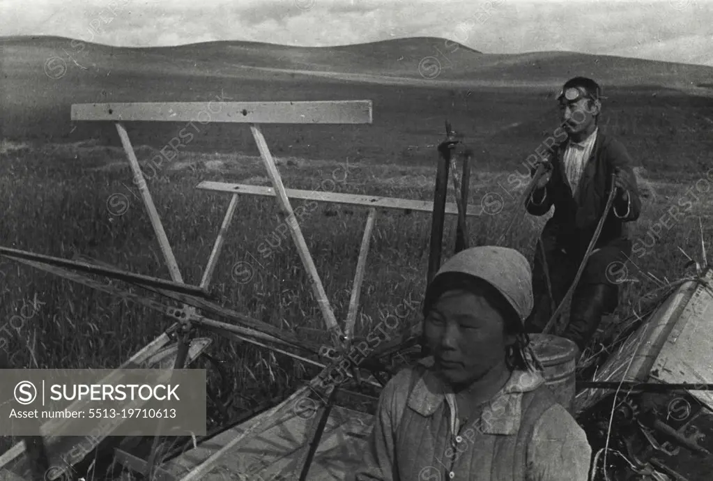 Harvesting Grain in Soviet Buryat-Mongolia (Eastern Siberia).Collective farmers of Buryat-Mongolia operate a sheaf-binder in the harvest field.The Buryat-Mongolian Autonomous Soviet Socialist Republic is located to the West of Lake Baikal in Eastern Siberia of the Soviet Union. Its vast territory reaches over 400,000 sq.km. Before the Great Proletarian Revolution it was a Tsarist colony, land of convict labor and exile. The oppressed people of Buryat-Mongolia did not even have their own schools. Now the country is developing its cultural and economic life. January 1, 1937. (Photo by Zelma).