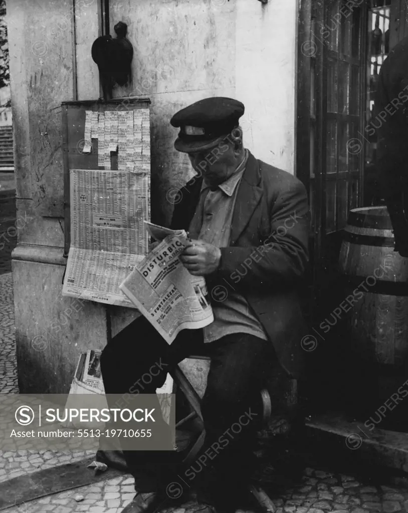 Lisbon 1952 -- A typical vendor of State lottery tickets reads his daily paper. February 27, 1952. (Photo by Sequiera, Camera Press).